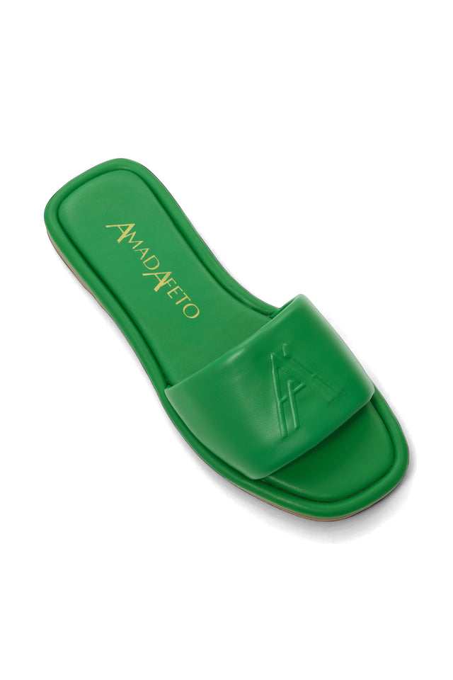 Detailed view of womens leather green slides